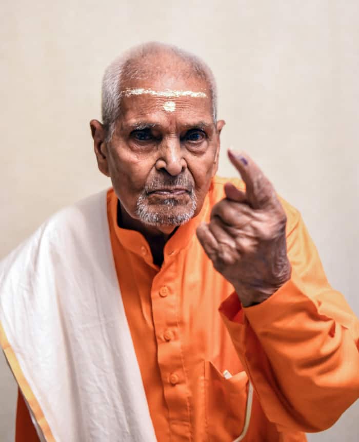A 107-year-old elderly voter named Radhika Prashad Mishra casts his vote for the sixth phase of Lok Sabha Polls