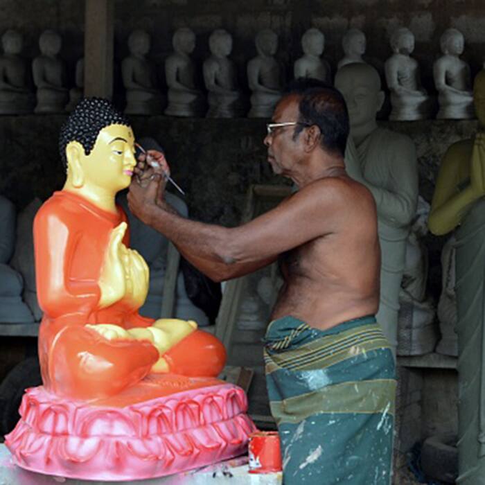 Artist carving out Lord Buddha   s statue
