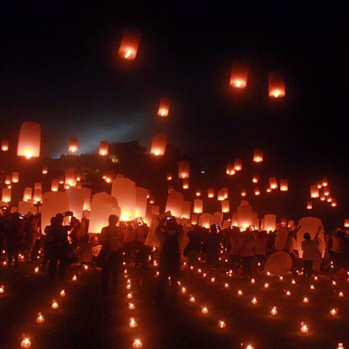 Buddhist devotees flying  lanterns