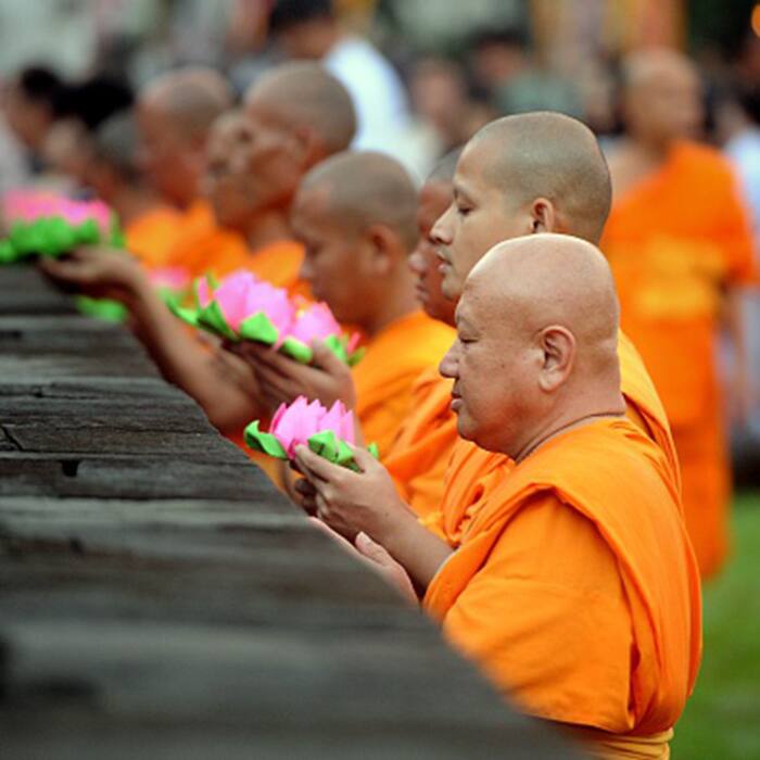 Buddhist monks offering prayers and meditating