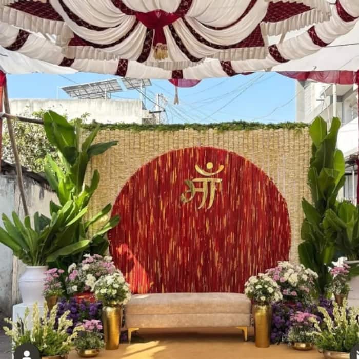 Chaitra Navratri 2026: Kalava backdrop decoration idea with plants and white flowers