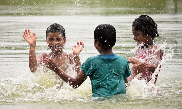 Children splash in a village pond to beat the heat amid soaring temperatures and inadequate rainfall despite the onset of the monsoon, in Nadia district, West Bengal