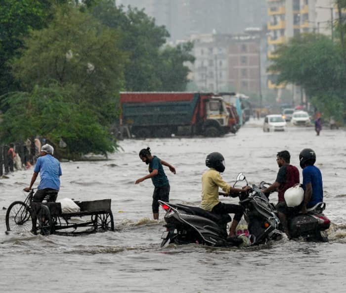 Commuters wade through waterlogged streets as heavy rain lashes Delhi-NCR