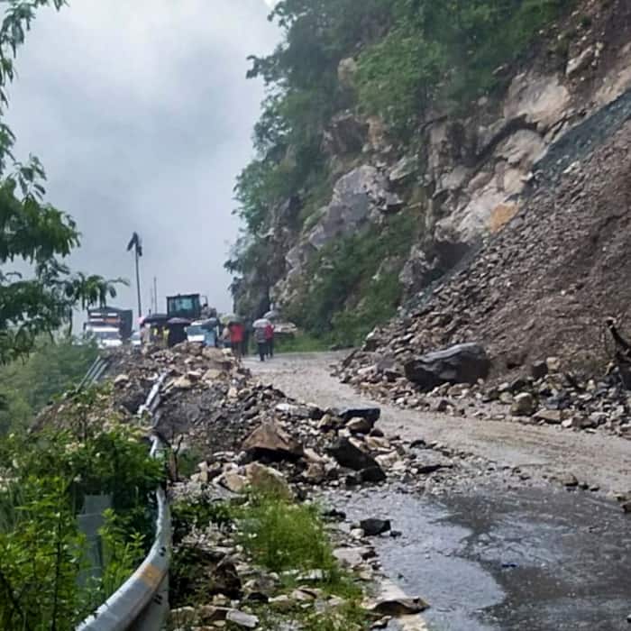 Debris and boulders block a road near Sayana Chatti following a landslide triggered by heavy rainfall, in Uttarkashi district