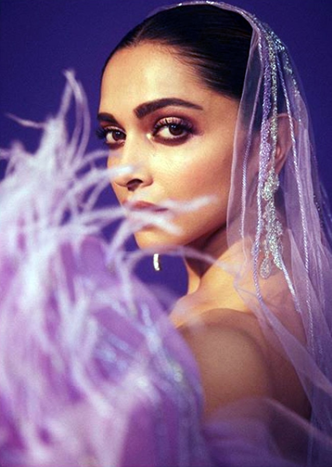 deepika padukone purple dress Deepika Padukone looks dramatic an electric violet gown #GauravGuptaCouture  with a gossamer tulle hood complimented with a soft feather trail. Find the  designer's collection at the Aza stores and online here at