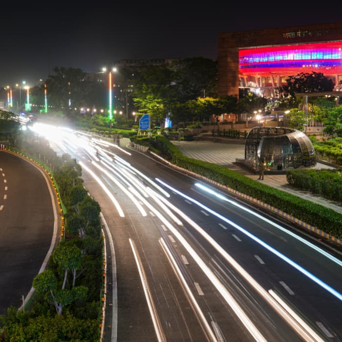 Light trails of moving vehicles seen on a road amid preparations ahead of the BRICS Summit, near Bharat Mandapam.