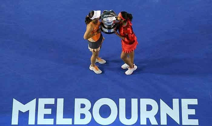 Martina Hingis and Sania Mirza hold their trophy aloft after winning Australian Open 2016 womens doubles title.