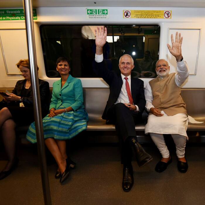 Narendra Modi and Australian PM Malcolm Turnbull waving to camera inside Delhi metro