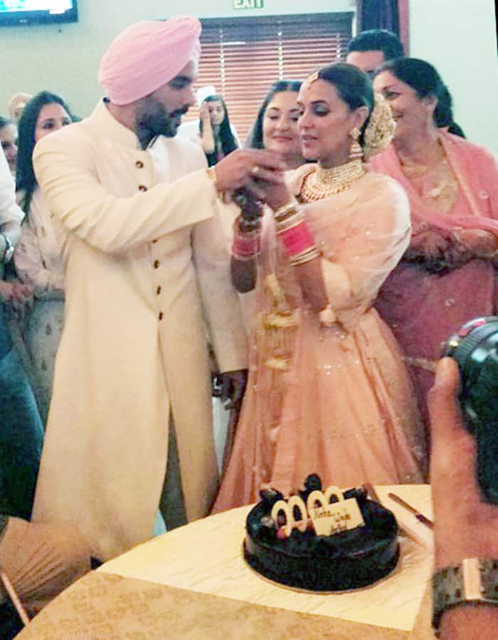 Neha Dhupia and Angad Bedi during cake cutting ceremony