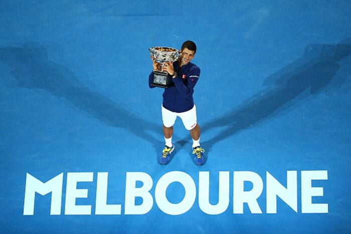 Novak Djokovic hold his trophy aloft after winning Australian Open 2016