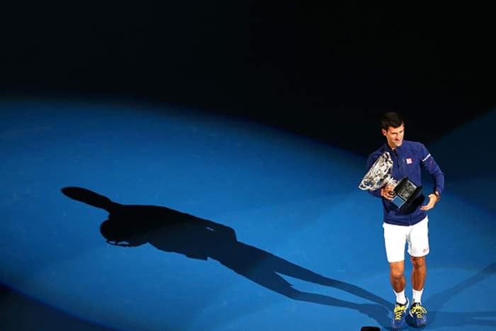 Novak Djokovic poses for cameras after winning Australian Open 2016