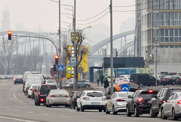People queue to a petrol station in Kyiv