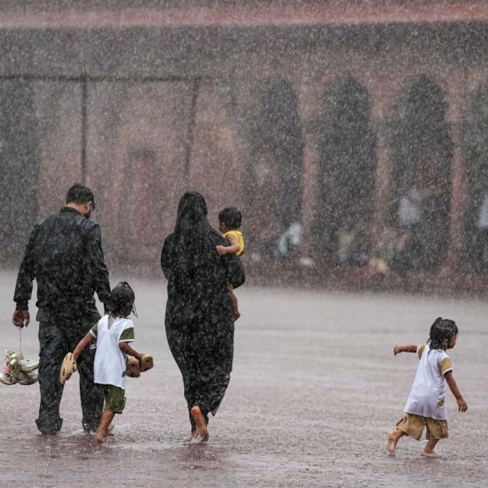 People visit the Jama Masjid amid heavy rainfall, in New Delhi, Tuesday