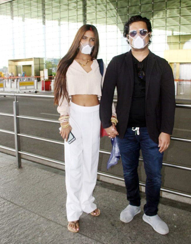 Poonam Pandey wears a light pink crop top with white pants
