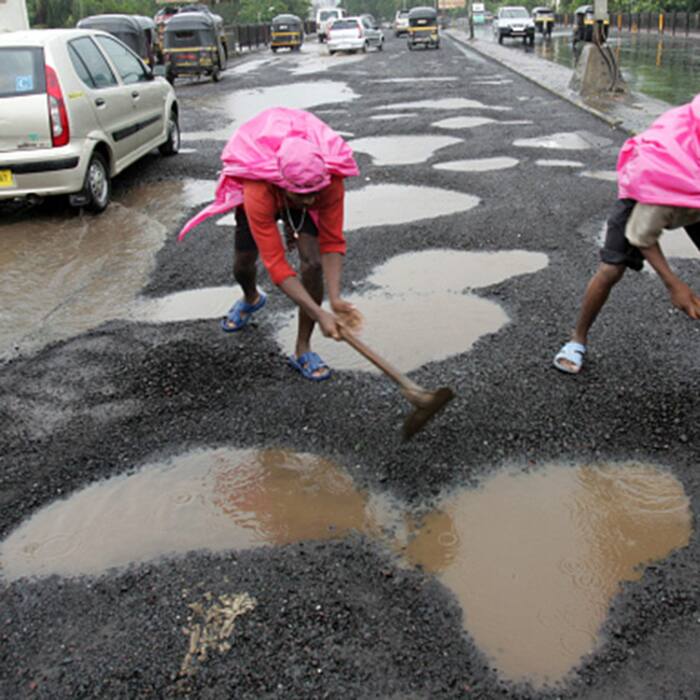 Potholes are being repaired during rains by BMC at Andheri flyover
