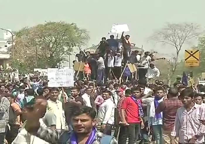 Protesters stop a train in Jaipur  Rajasthan during Bharat Bandh