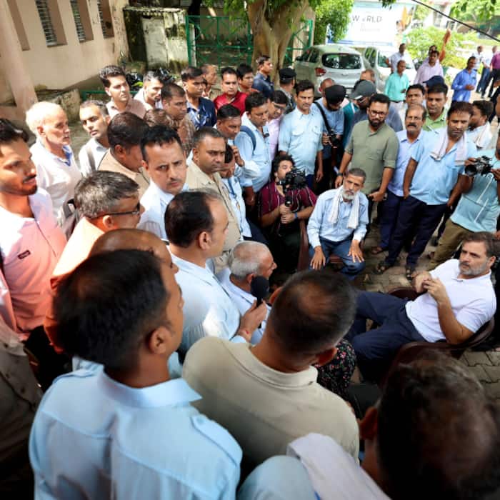 Rahul Gandhi interacts with a DTC staff after taking a DTC bus ride at Sarojini Nagar Bus depot