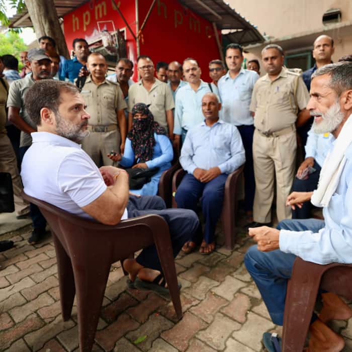 Rahul Gandhi interacts with a DTC staff after taking a ride on the DTC bus at Sarojini Nagar Bus depot in New Delhi on Wednesday