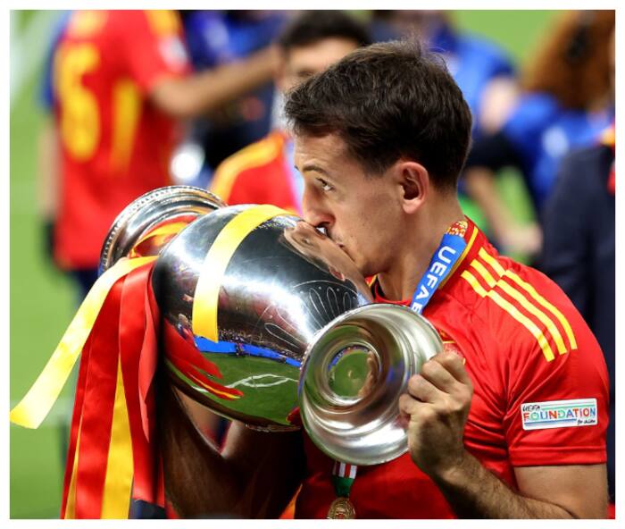 Spain s Mikel Oyarzabal kisses the Euro 2024 trophy after they beat England in the final 