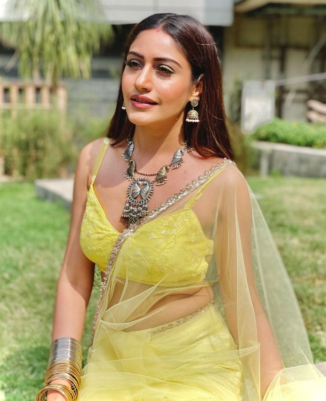 Surbhi Chandna shows off her curves in a yellow saree