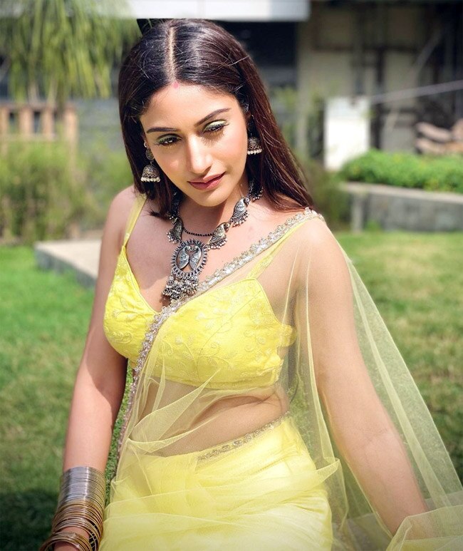 Surbhi Chandna wears a yellow backless blouse with a net saree