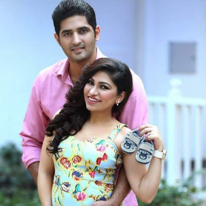 Tulsi Kumar with infant shoes in hands