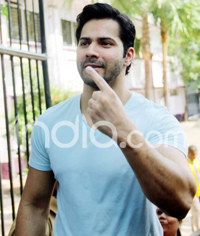 Varun Dhawan smiles for the paparazzi at a polling booth in Mumbai