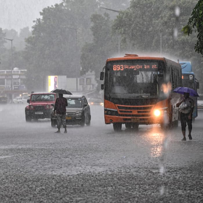 Vehicles wade during monsoon showers near Connaught Place, in New Delhi