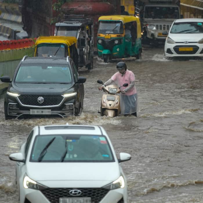 Vehicles wade through a waterlogged road amid rainfall, at Kashmere Gate, in New Delhi