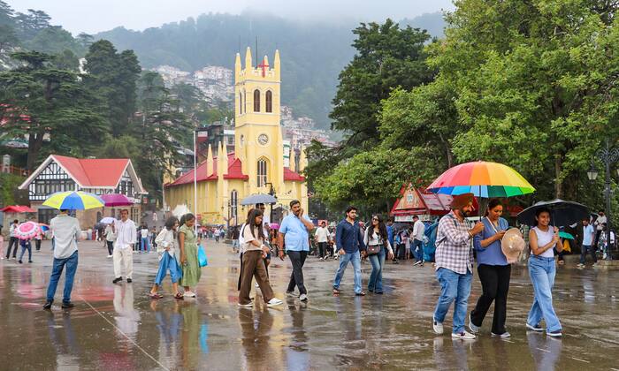 Visitors walk with umbrellas amid rain in Shimla (1)