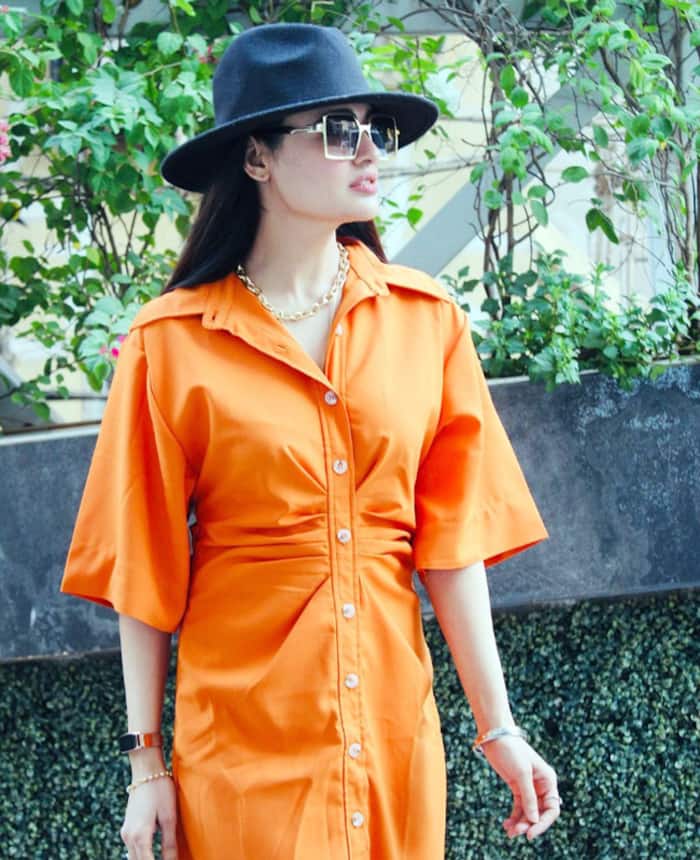 Yuvika Chaudhary looks adorable in an orange dress with black boots