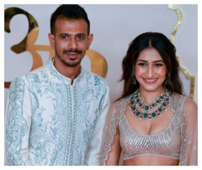 Yuzvendra Chahal and hi wife Dhanashree Verma pose for photographs at Anant Ambani-Radhika Merchant wedding.